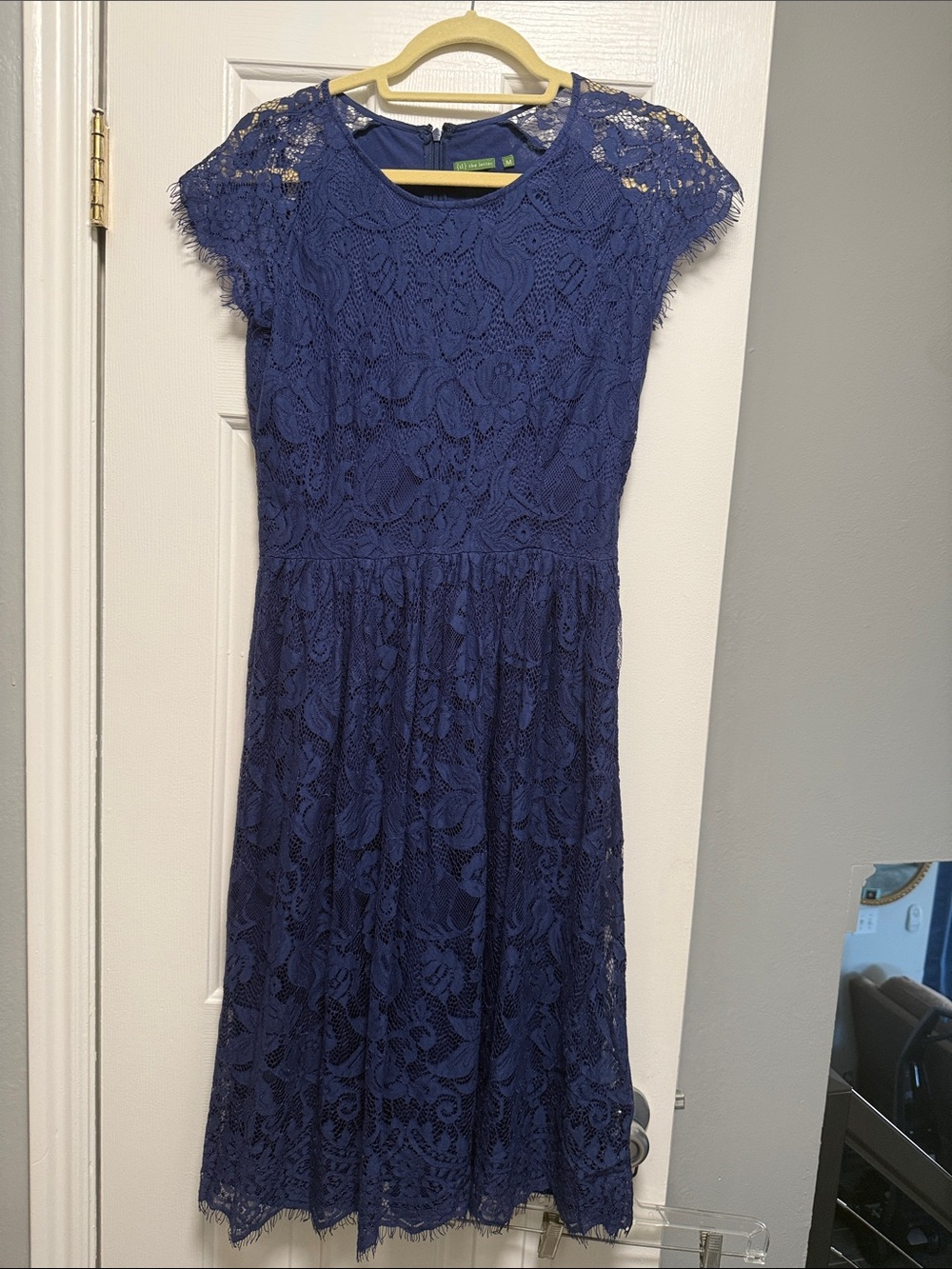 a {tl} the letter navy blue lace dress with a medium size tag.